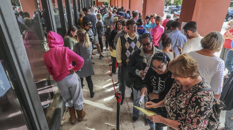 People lined up for early voting Thursday at the Cobb County West Park Government Center in Marietta. JOHN SPINK/JSPINK@AJC.COM