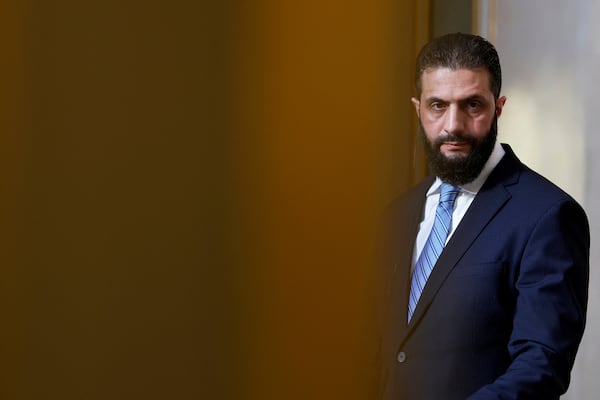 Syria's interim President Ahmad al-Sharaa, listens during a joint press conference with French President Emmanuel Macron after a meeting at the Elysee Palace in Paris, Wednesday, May 7, 2025. (Stephanie Lecocq/Pool via AP)