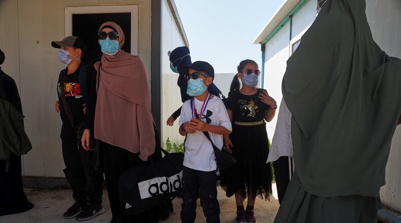Members of Australian families at Roj Camp in eastern Syria, housing people with alleged ties to Islamic State militants, prepare to leave for Damascus as part of a second repatriation effort by Syrian authorities, at Roj Camp in eastern Syria, Friday, April 24, 2026. (AP Photo/Baderkhan Ahmad)