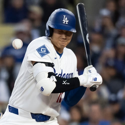 Los Angeles Dodgers' Shohei Ohtani is hit by a pitch during the first inning of a baseball game against the New York Mets in Los Angeles, Monday, April 13, 2026. (AP Photo/Kyusung Gong)