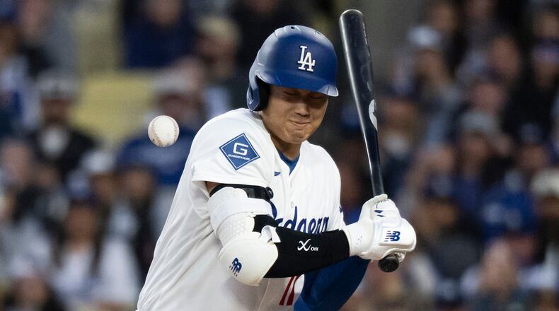 Los Angeles Dodgers' Shohei Ohtani is hit by a pitch during the first inning of a baseball game against the New York Mets in Los Angeles, Monday, April 13, 2026. (AP Photo/Kyusung Gong)