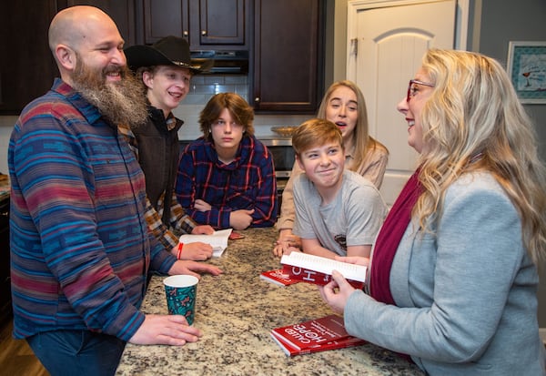 Joel Koeppen (from left), Breydan, Elijah, Avery and Hannah laugh at a story Sarah tells in their Dallas home. Sarah is the Founder and Executive Director of The Hope Box, a nonprofit that helps to stop abandonment of newborns by reaching out to moms in crisis. PHIL SKINNER FOR THE ATLANTA JOURNAL-CONSTITUTION.