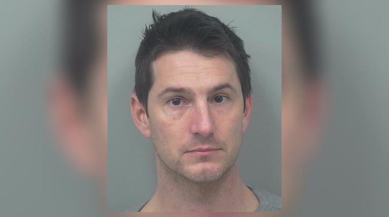 Former Norcross police Officer Kevin Shawn Day was arrested Tuesday on charges he pandered a prostitute for sex, misused law enforcement databases and violated his oath as a police officer.