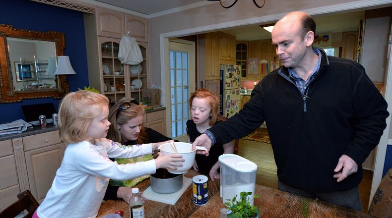 Darden Glass, third from left, 8, who who has Down Syndrome, and sister Anna, 6, help their parents Betsy and David Glass as they makes their popular fudge pie Darden’s Dangerously Delicious Fudge Pie at their home in Sandy Springs. What began as a contribution to a school bake sale for Glass and her husband David has turned into a full-fledge business called Darden’s Delights, named for Darden who has Down Syndrome. The Glasses donate a large portion of their revenue to organizations that support people with developmental disabilities.