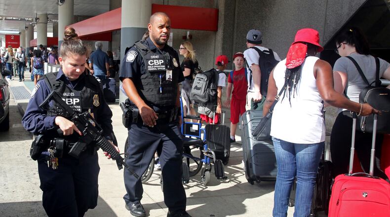 A heavy police presence was at the Ft. Lauderdale-Hollywood International Airport after it re-opened Saturday, Jan. 7, 2017. Investigators continued their work downstairs in the baggage area of terminal 2 the day after a shooting. (Mike Stocker /South Florida Sun-Sentinel via AP)