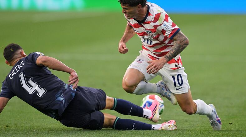Paraguay's Juan Jose Caceres (4) tackles United States' Christian Pulisic (10) during the World Cup Group D soccer match in Inglewood, Calif., near Los Angeles, Friday, June 12, 2026. (AP Photo/Jayne Kamin-Oncea)