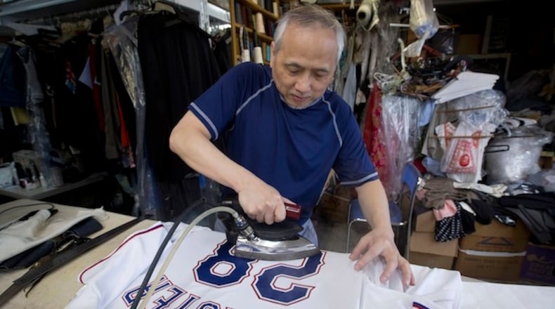 Texas Rangers' tailor Aman Li works on a jersey for manager Jeff Bannister for opening day at his business Lee's Tailor Couture in Fort Worth, Texas, on March 31, 2016. (Joyce Marshall/Fort Worth Star-Telegram/TNS)