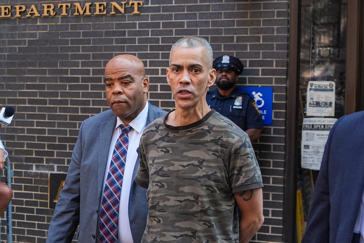 Raul Morales, a 51-year-old man who is accused of stabbing two people on the Upper West Side in Manhattan on Thursday afternoon is escorted out of the NYPD 20th Precinct by police officers in New York, Friday, July 24, 2026. (AP Photo/Ryan Murphy)