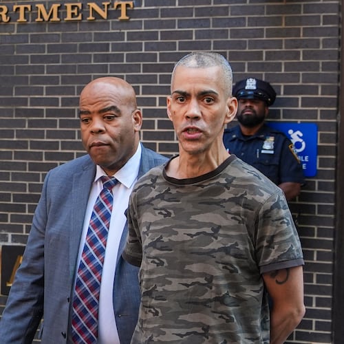 Raul Morales, a 51-year-old man who is accused of stabbing two people on the Upper West Side in Manhattan on Thursday afternoon is escorted out of the NYPD 20th Precinct by police officers in New York, Friday, July 24, 2026. (AP Photo/Ryan Murphy)