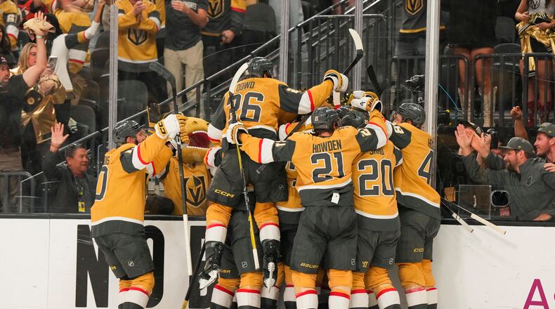 The Vegas Golden Knights celebrate defeating the Anaheim Ducks during overtime of Game 5 of a second-round NHL hockey Stanley Cup playoff series Tuesday, May 12, 2026, in Las Vegas. (AP Photo/Candice Ward)
