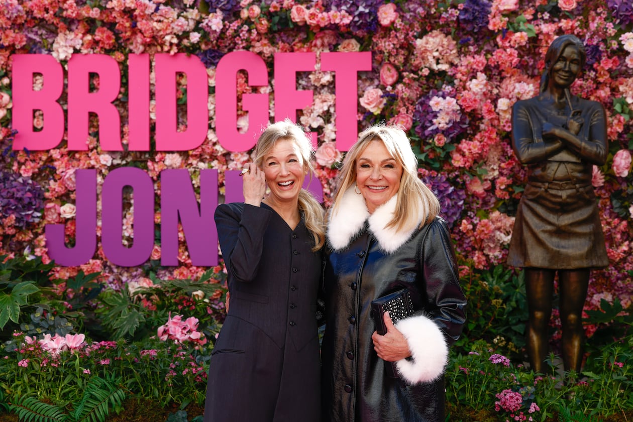 Renee Zellweger, left, and writer Helen Fielding pose for photographers during the unveiling of the Bridget Jones statue in Leicester Square, London, Monday, Nov. 17, 2025. (Photo by Millie Turner/Invision/AP)