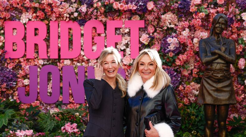 Renee Zellweger, left, and writer Helen Fielding pose for photographers during the unveiling of the Bridget Jones statue in Leicester Square, London, Monday, Nov. 17, 2025. (Photo by Millie Turner/Invision/AP)