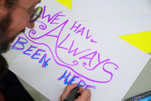 Gabriel Faith, of Newark, N.J., makes a sign during a pre-rally for the National Trans Visibility March, at the Human Rights Campaign, before marching to join the World Pride Rally on the National Mall, Sunday, June 8, 2025, in Washington. (AP Photo/Jacquelyn Martin)