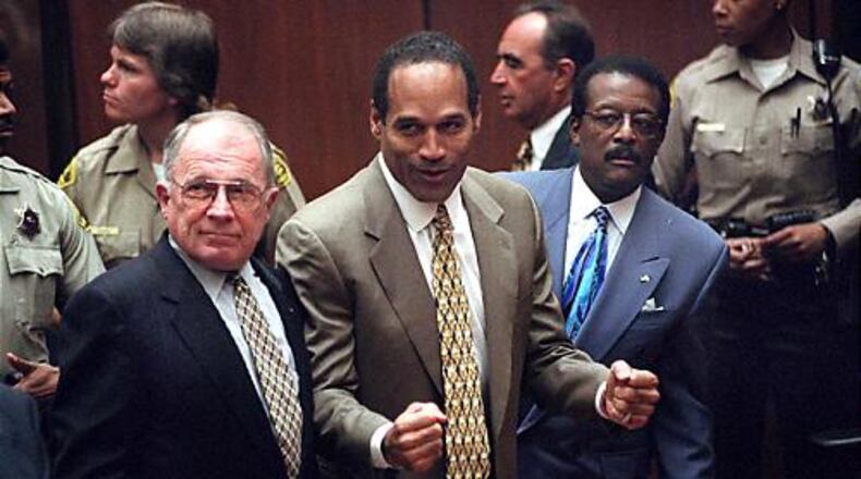 O.J. Simpson reacts as he is found not guilty of murdering his ex-wife Nicole Brown Simpson and her friend Ron Goldman at the Criminal Courts Building in Los Angeles on Oct. 3, 1995. At left is defense lawyer F. Lee Bailey and at right, defense attorney Johnnie Cochran Jr. Defense attorney Robert Shapiro is in profile behind them. Bailey died Thursday in Georgia.