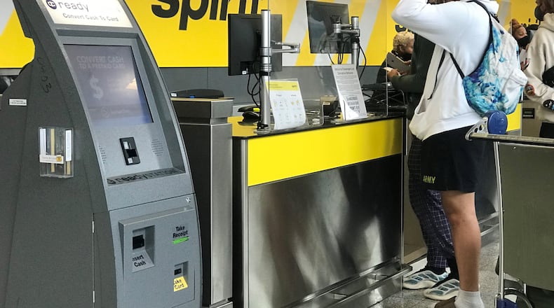 Passengers seek assistance at the Spirit Airlines check-in counter at Hartsfield-Jackson.