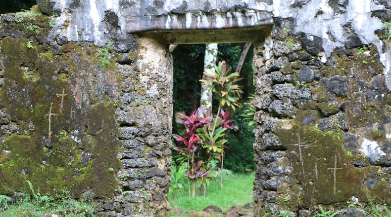 This undated photo, provided by the Hawaii Department of Land and Natural Resources, shows crosses etched by vandals on the crumbling remains of the 180-year-old summer palace of former King Kamehameha III in the forest of a Honolulu, Hawaii, neighborhood. The Department said Thursday, June 23, 2016, that unless the vandals are caught desecrating the sacred cultural site, there’s little law enforcement officers can do. (Hawaii Department of Land and Natural Resources via AP)
