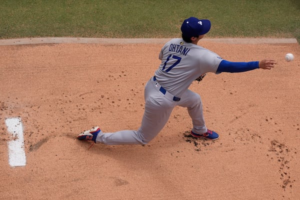 Los Angeles Dodgers starting pitcher Shohei Ohtani warms up before a baseball game against the Kansas City Royals, Saturday, June 28, 2025, in Kansas City, Mo. (AP Photo/Charlie Riedel)