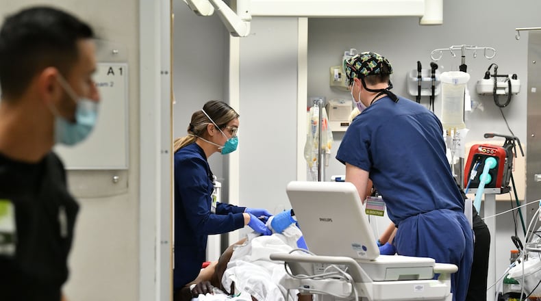 Medical staff treat a patient in a trauma room in the Emergency and Trauma Center at Northeast Georgia Medical Center (NGMC) in Gainesville in January. NGMC, which has four hospital campuses, has received about $77 million in federal relief funds, federal data show. NGMC told the AJC it had reduced executive compensation, as well as delayed or reduced capital expansion projects, among other cost-cutting measures, during the pandemic. (Hyosub Shin / Hyosub.Shin@ajc.com)