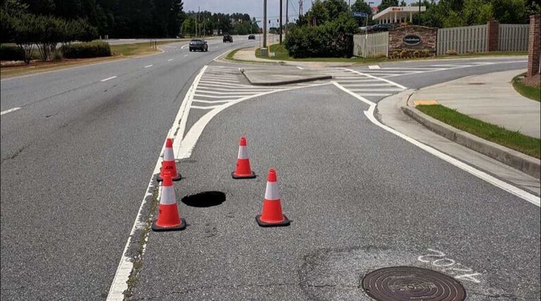 This sinkhole opened up at State Bridge Road and Mannes Lane, the Johns Creek police said Sunday, June 2, 2019.