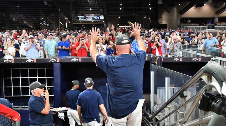 Braves manager Brian Snitker waves to fans after his team won the NL East championship Thursday, Sept. 30, 2021, at Truist Park in Atlanta. (Hyosub Shin / Hyosub.Shin@ajc.com)
