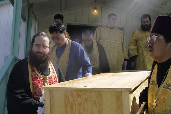 Church officials move the relics, or remains, of Matushka Olga Michael from the church to a nearby graveyard for one last ceremony before her canonization ceremony to become St. Olga, in Kwethluk, Alaska, on June 19, 2025. (AP Photo/Mark Thiessen)