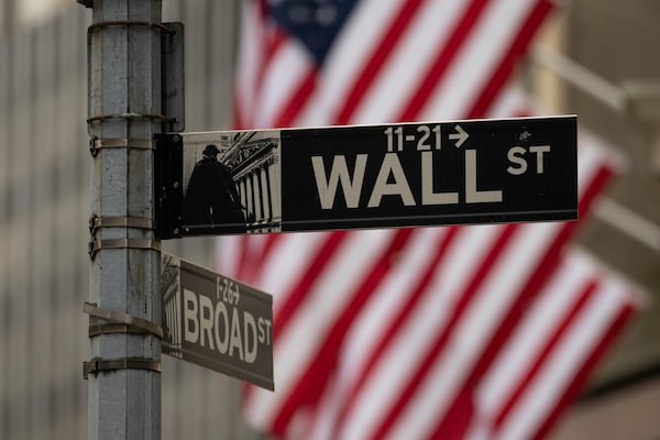 A Wall Street sign hangs near to the New York Stock Exchange, Wednesday, June 18, 2025, in New York. (AP Photo/Yuki Iwamura)