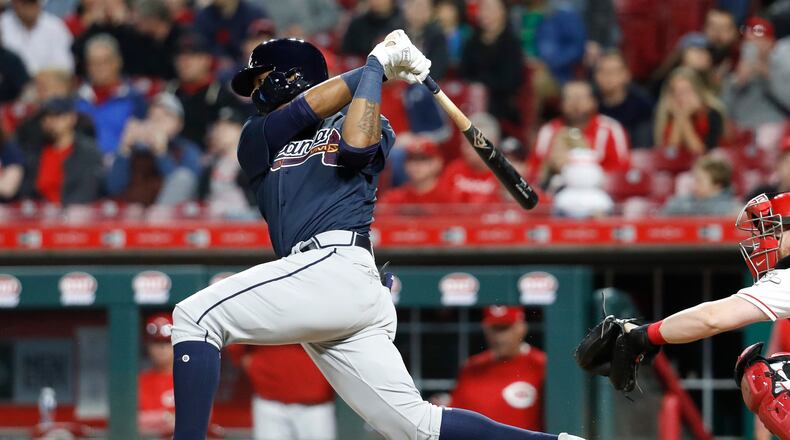 Braves' Ronald Acuna Jr. follows through on a single off Cincinnati Reds relief pitcher Kevin Shackelford during the eighth inning Wednesday, April 25, 2018, in Cincinnati.