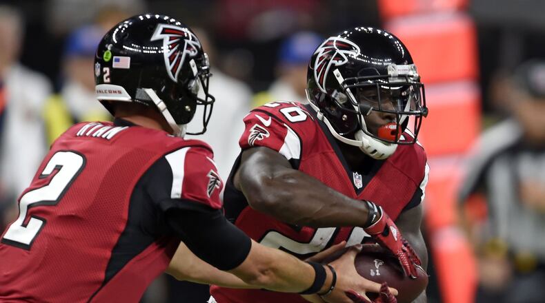 Atlanta Falcons quarterback Matt Ryan (2) hands off to running back Tevin Coleman (26) in the first half of an NFL football game in New Orleans, Monday, Sept. 26, 2016. (AP Photo/Bill Feig)