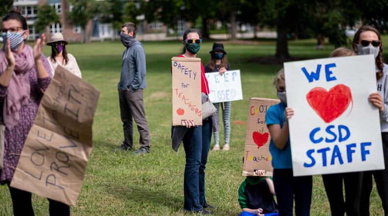 Decatur-Kathryn Antman, a teacher in Clayton County whose son attends Fifth Avenue Elementary School in Decatur, joins with other teachers and parents to protest the City Schools of Decatur reopening plan in front of the school’s headquarters in downtown Decatur on Tuesday, Sept. 22, 2020. Ben Gray for the Atlanta Journal-Constitution
