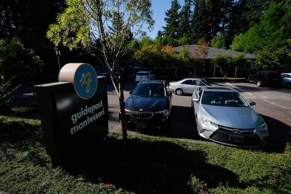 Children are dropped off at the Guidepost Montessori school on Friday, July 18, 2025, in Beaverton, Ore. (AP Photo/Jenny Kane)