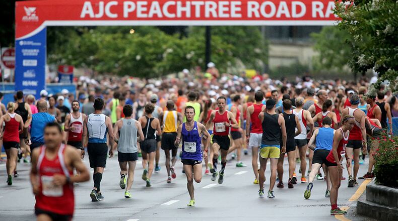 July 4, 2015 - Atlanta, Ga: Runners warm-up before the start of the 46th running of the Atlanta Journal-Constitution Peachtree Road Race Saturday morning in Atlanta, Ga., July 4, 2015. JASON GETZ / PHOTO