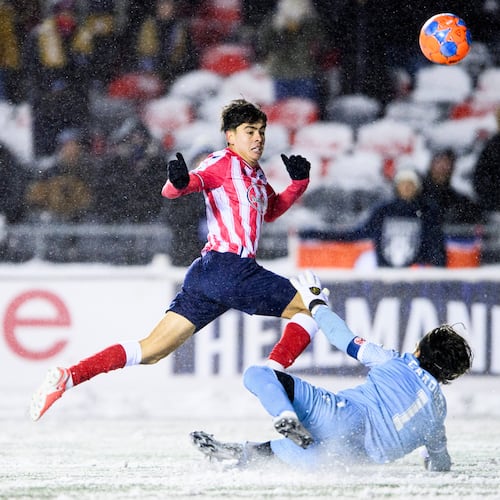 Atletico Ottawa's David Rodríguez (7) scores on Cavalry FC's Ali Musse (7) during extra time Canadian Premier League finals soccer action in Ottawa, on Sunday, Nov. 9, 2025. (Spencer Colby/The Canadian Press via AP)