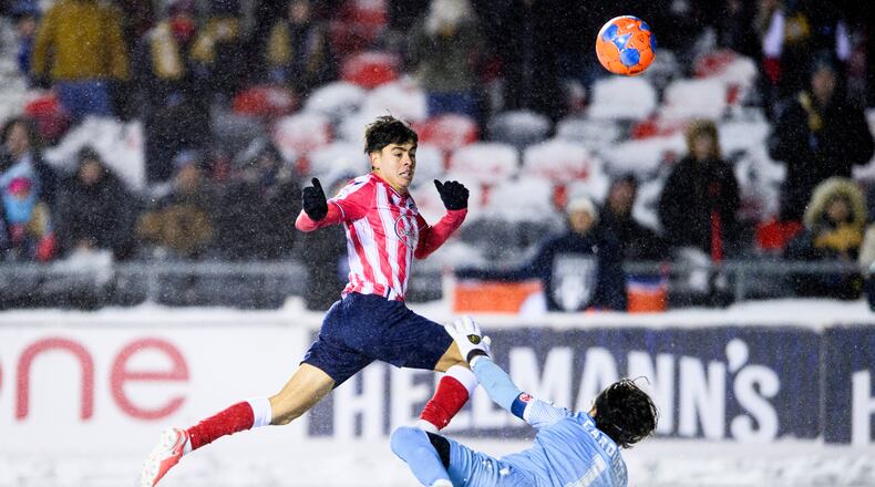 Atletico Ottawa's David Rodríguez (7) scores on Cavalry FC's Ali Musse (7) during extra time Canadian Premier League finals soccer action in Ottawa, on Sunday, Nov. 9, 2025. (Spencer Colby/The Canadian Press via AP)