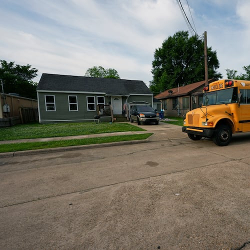 A school bus passes the house where 8 children were killed during a mass shooting the day before in Shreveport, La., Monday, April 20, 2026. (AP Photo/Gerald Herbert)
