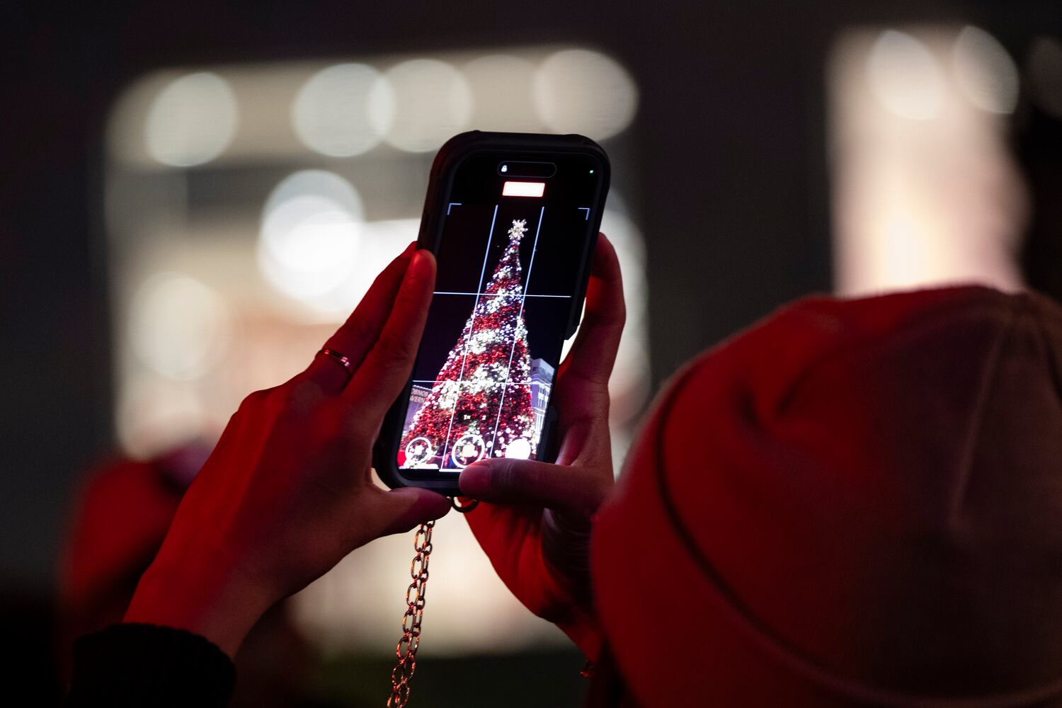 A person shoots a photo of the Christmas tree at Atlantic Station in Atlanta on Saturday, Nov. 23, 2024.   Ben Gray for the Atlanta Journal-Constitution