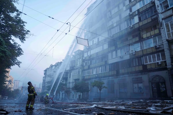 Rescue workers put out a fire of a residential house heavily damaged by a Russian strike in Kyiv, Ukraine, on Thursday, July 10, 2025. (AP Photo/Evgeniy Maloletka)