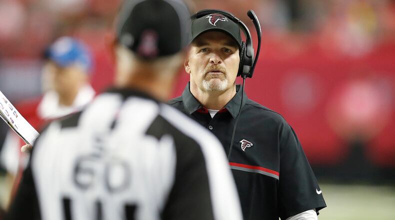 Atlanta Falcons head coach Dan Quinn speaks with side judge Gary Cavaletto (60) during the second half of an NFL football game against the San Diego Chargers, Sunday, Oct. 23, 2016, in Atlanta. (AP Photo/John Bazemore)