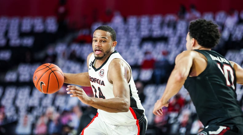 Georgia basketball player P.J. Horne (24) dribbles past a defender during a game against South Carolina at Stegeman Coliseum in Athens on Saturday, Feb. 27, 2021. (Photo by Tony Walsh/UGA Athletics)