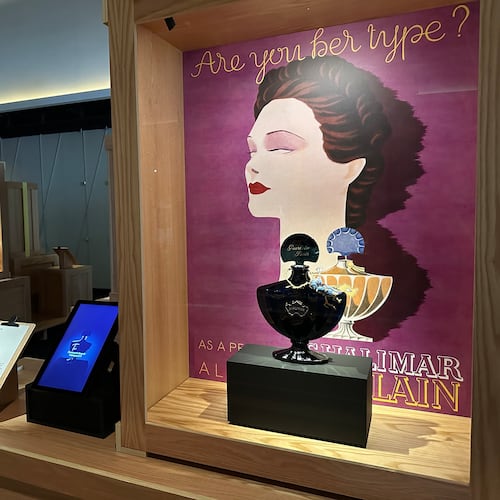 An advertisement from 1935 and a midnight-blue perfume bottle for Jacques Guerlain's Shalimar fragrance pictured on are display as part of the Comite Colbert "Hidden Treasures" exhibit at The Shed on Tuesday, May 26, 2026, in New York. (AP Photo/Beatrice Dupuy)