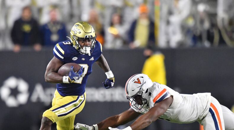 Georgia's Tech Hassan Hall runs past Virginia’s Paul Akere during the second half of the October meeting between the teams at Bobby Dodd Stadium.