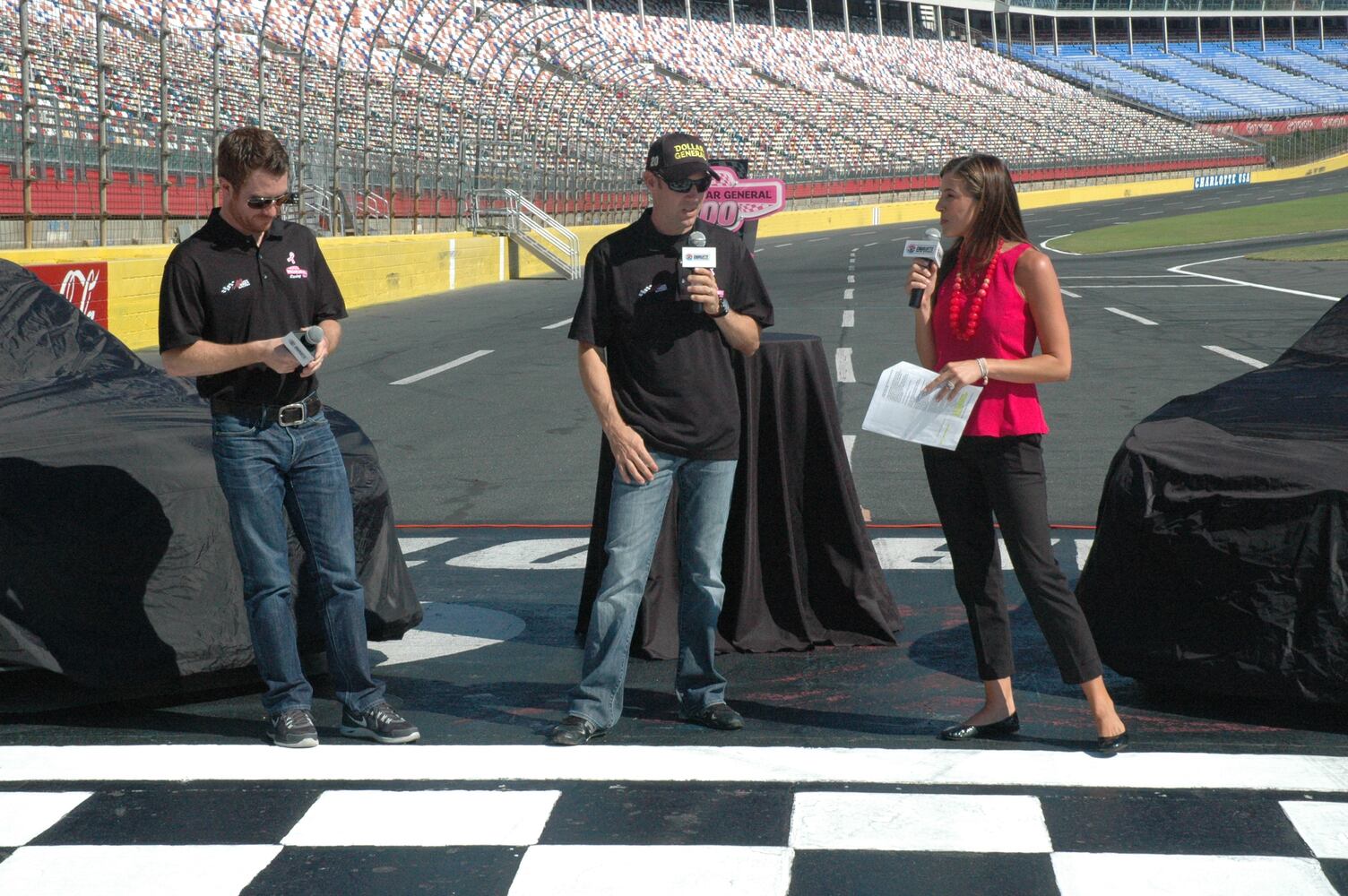 IMAGES: NASCAR drivers, breast cancer survivors paint pit road pink