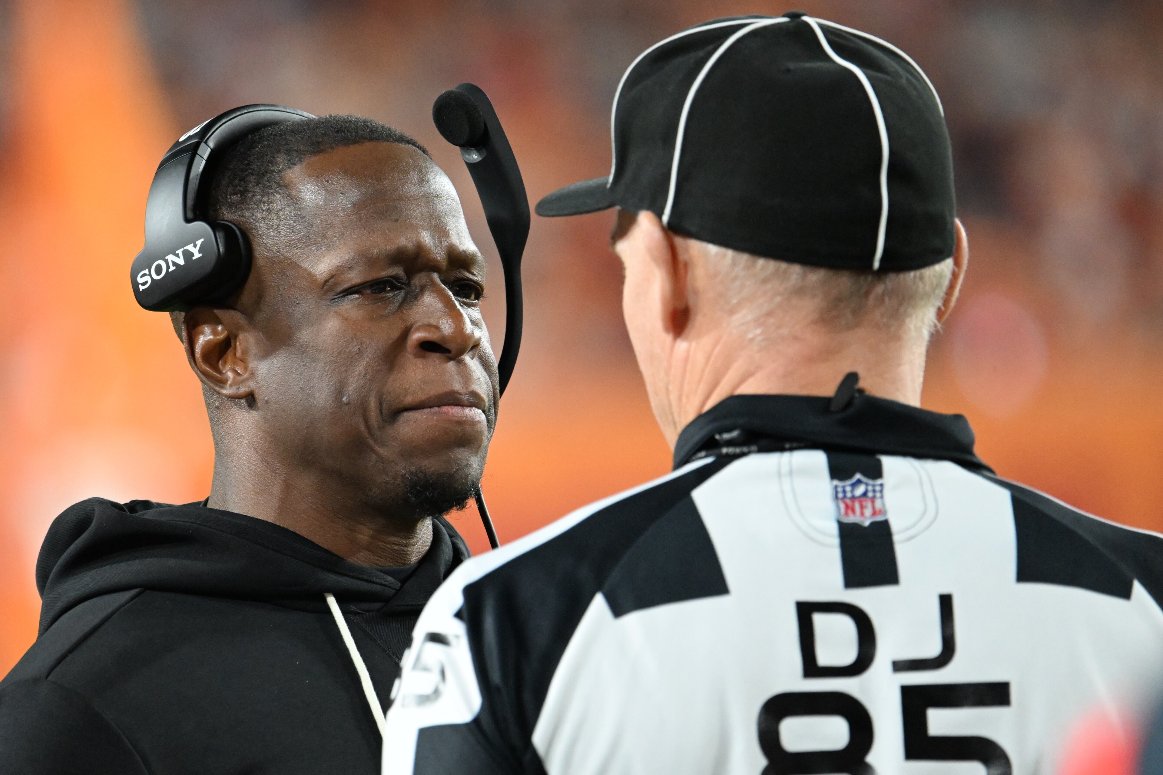 Atlanta Falcons head coach Raheem Morris speaks to down judge Daniel Gallagher (85) during the first half of an NFL football game against the Tampa Bay Buccaneers, Thursday, Dec. 11, 2025, in Tampa, Fla. (AP Photo/Jason Behnken)