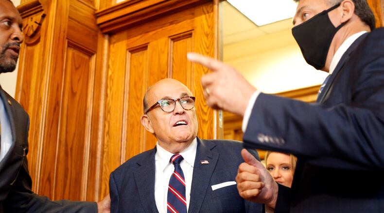 Rudy Giuliani walks to a senate hearing at the Georgia State Capitol in Atlanta on Thursday, December 3, 2020. The Georgia Senate Committee on Judiciary has formed a special subcommittee to take testimony of elections improprieties and evaluate the election process. (Rebecca Wright for the Atlanta Journal-Constitution)