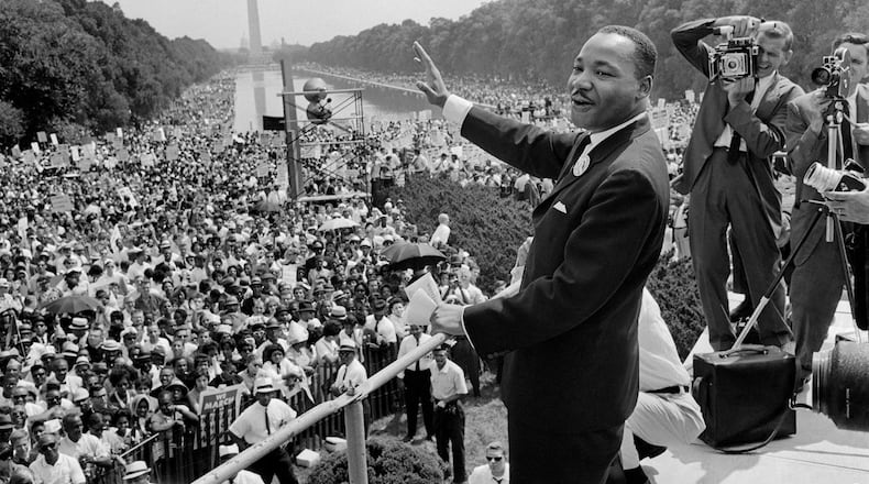 US civil rights leader Martin Luther King Jr. (center) waves to supporters on Aug. 28, 1963, in Washington D.C. during the "March on Washington," where King delivered his famous "I Have a Dream" speech. (-/AFP via Getty Images/TNS)