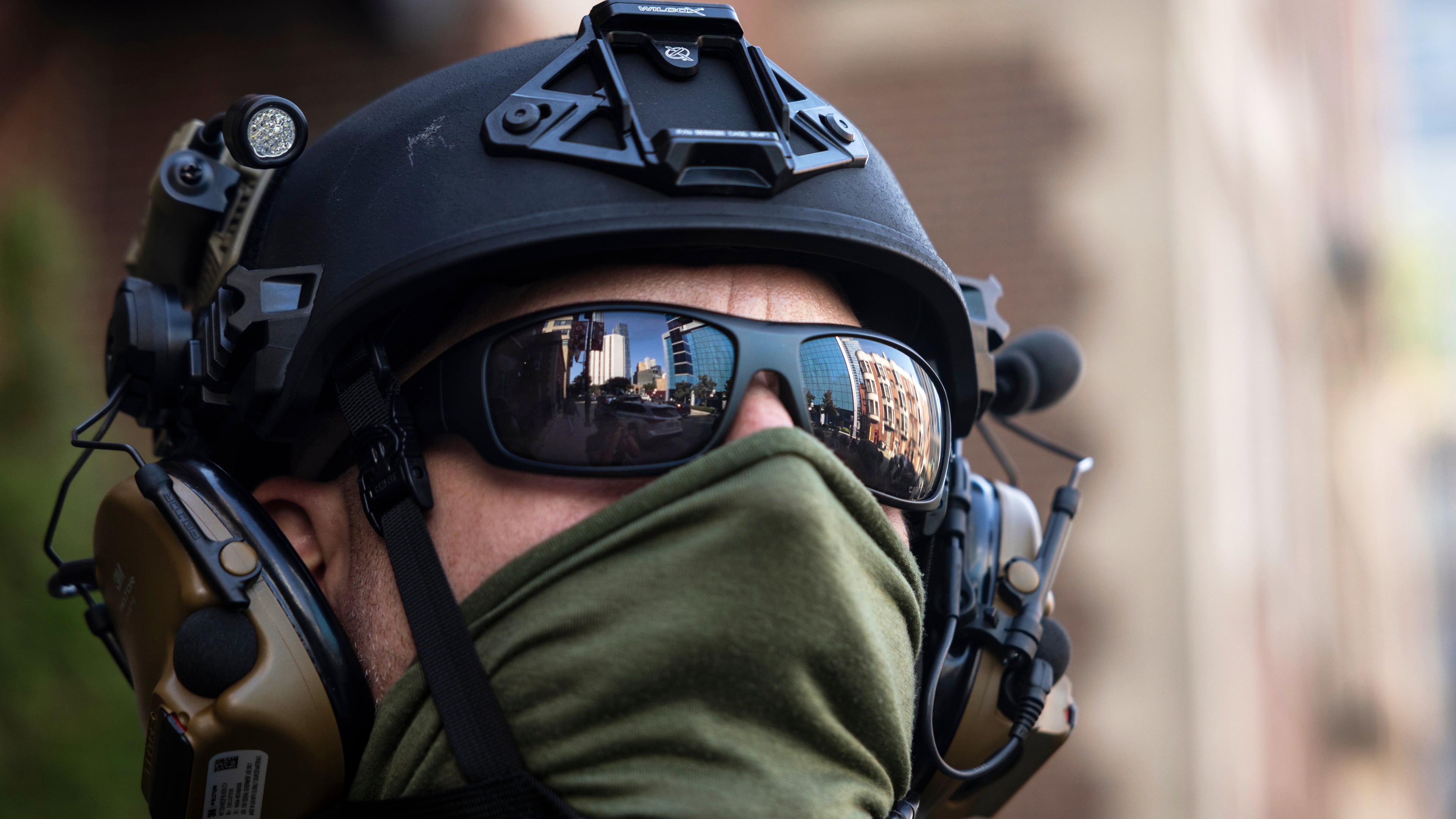 FILE - Federal immigration enforcement agents keep watch as they detain a man who took off running as they were walking on North Clark Street near West Superior Street in the River North neighborhood, Sept. 28, 2025, in Chicago. (Ashlee Rezin/Chicago Sun-Times via AP, File)