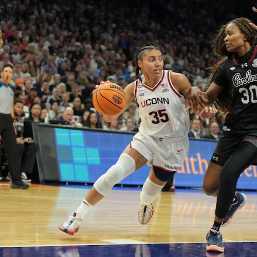 UConn guard Azzi Fudd (35) drives against South Carolina forward Maryam Dauda (30) during the first half of a woman's NCAA college basketball tournament semifinal game at the Final Four, Friday, April 3, 2026, in Phoenix. (AP Photo/Rick Scuteri)