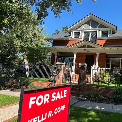 FILE - A for sale sign stands outside a home on the market in the Alamo Placita neighborhood Tuesday, Aug. 27, 2024, in central Denver. (AP Photo/David Zalubowski, File)