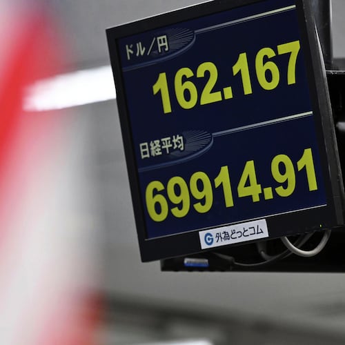 An electronic board shows Japan's benchmark Nikkei 225 index, bottom, and exchange rate of the Japanese yen against the U.S. dollar in Tokyo Tuesday, June 30, 2026. (Kenichiro Kojima/Kyodo News via AP)