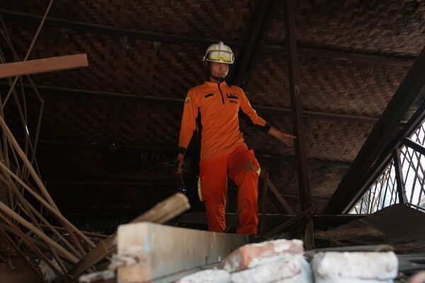 A rescuer works through rubble of a collapsed building following Friday's earthquake in Naypyitaw, Myanmar, Tuesday, April 1, 2025. (AP Photo)