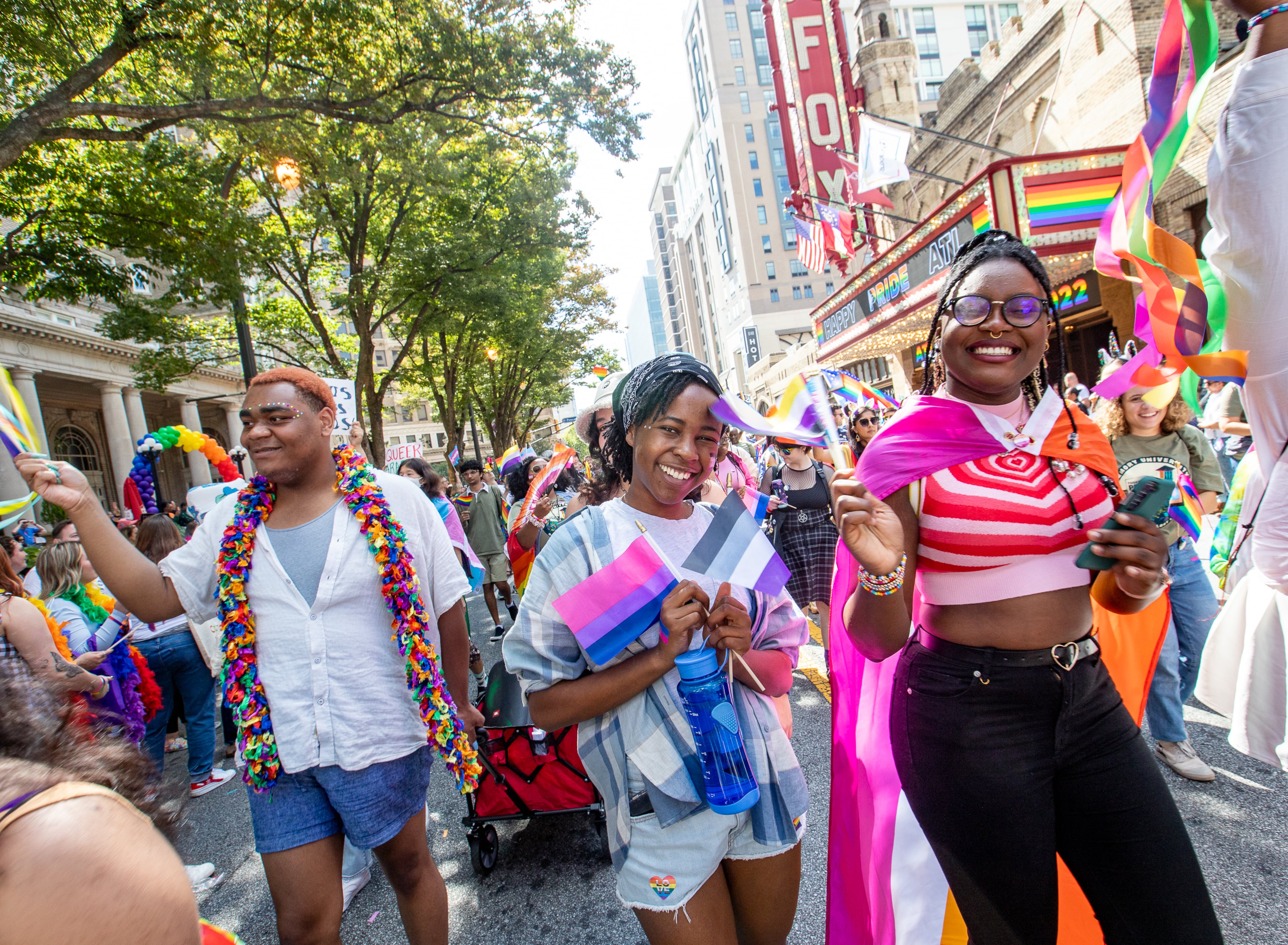 Emory students, including Malia Wakesho-Ajwang (center) and Mariam Egberongbe (right), participate in the Atlanta Pride Parade as it moves up Peachtree Street on Sunday, Oc.t 9, 2022. This was the first time the parade had been held since 2019 because of the pandemic. (Photo: Jenni Girtman for The Atlanta Journal-Constitution)